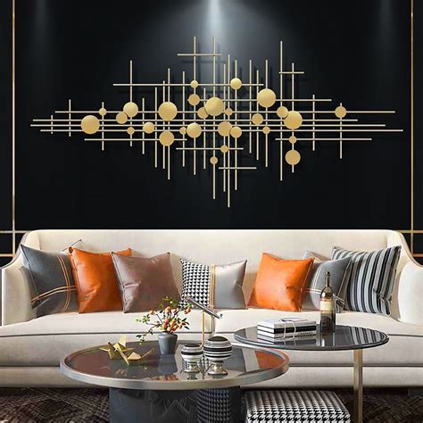 black and gold metal wall art|black wall with gold accents.